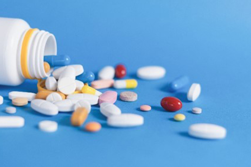 Colorful pills and tablets on background